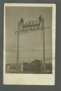 Sioux Falls SOUTH DAKOTA RPPC c1910 DAKOTA LAUNDRY Workers PUTTING UP SIGN