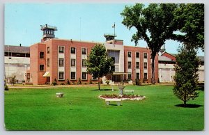 Michigan City Indiana~State Prison Bldg~Watch Tower~Flag~Fountain~1950s Postcard