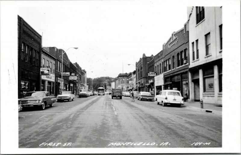 Monticello Iowa~First Street~Army Surplus Store~Hamm's Beer~1950s Cars~RPPC 