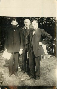 c1910s RPPC Stern Looking Men w/ Bibles, Christian Missionaries, Unknown US