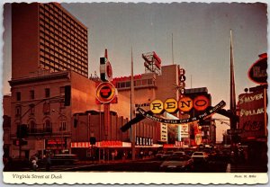 1970 Virginia St. at Dusk Reno Nevada Harrah's Hotel Old's Club Posted Postcard