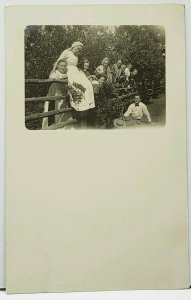 RPPC Home Garden Resting on Fence Women with Tongues Out Real Photo Postcard H12