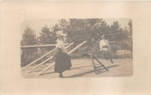 H32/ Greeley Colorado RPPC Postcard 1910 Playground See-Saw Woman