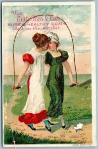 KISSING GIRLS ANTIQUE ADVERTISING VICTORIAN TRADE CARD