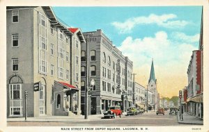 LACONIA NH~MAIN STREET FROM DEPOT SQUARE-STOREFRONTS-SIGNS~1920s POSTCARD