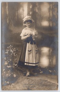RPPC Dirndl Peasant Style~He Loves Me Daisy~San Francisco Earthquake Msg~Bibbers