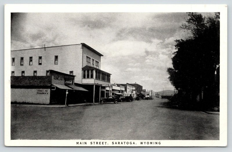 Saratoga Wyoming~Main Street~Donelan Pharmacy~Hotel~1930s Cars~B&W Postcard 