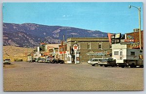 Gardiner Montana~Main Street Scene~Texaco Sign~Town Fountain Cafe~1950s Postcard