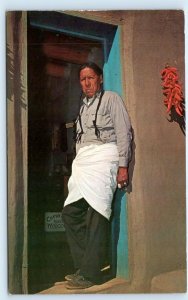 TAOS, NM New Mexico ~ Native American PUEBLO INDIAN in DOORWAY c1950s  Postcard