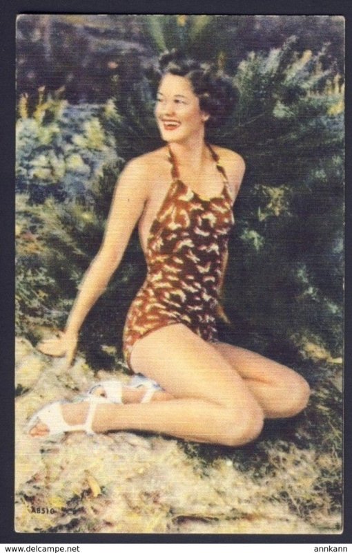 Swimsuit - pin-up woman brown one piece bathing suit, posing on sand