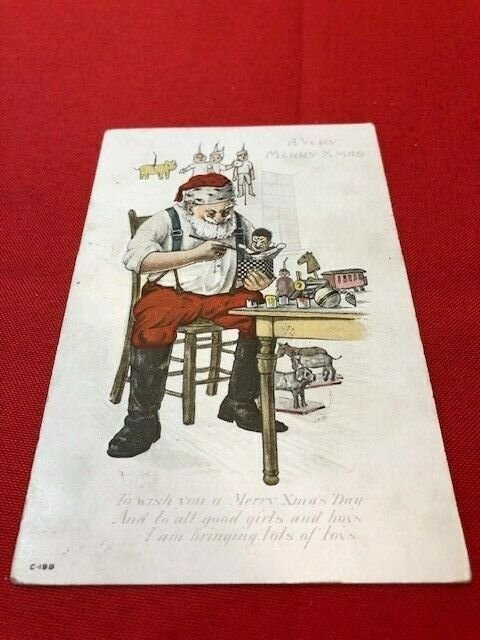 embossed postcard SANTA Making Toys With Robe Off and Sleeves Rolled Up 