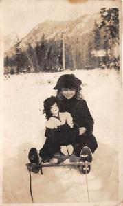 Little girl with doll in the snow Child, People Photo Writing on back 