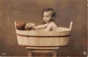 Little baby in wood bucket Child, People Photo Writing on back 