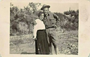 UNITED STATES SOLDIER HUGS WOMAN-REAL PHOTO POSTCARD