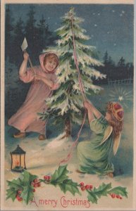 Postcard A Merry Christmas Girls Chopping Down a Christmas Tree