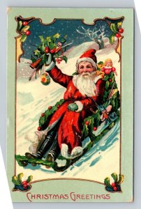 c1910 SANTA CLAUS SLEDDING, TOYS, DOLL, GUN EMBOSSED CHRISTMAS POSTCARD