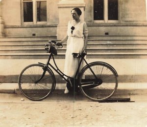 WOMAN WITH BICYCLE WEARING STYLISH PERIOD CLOTHING~1910s REAL PHOTO POSTCARD