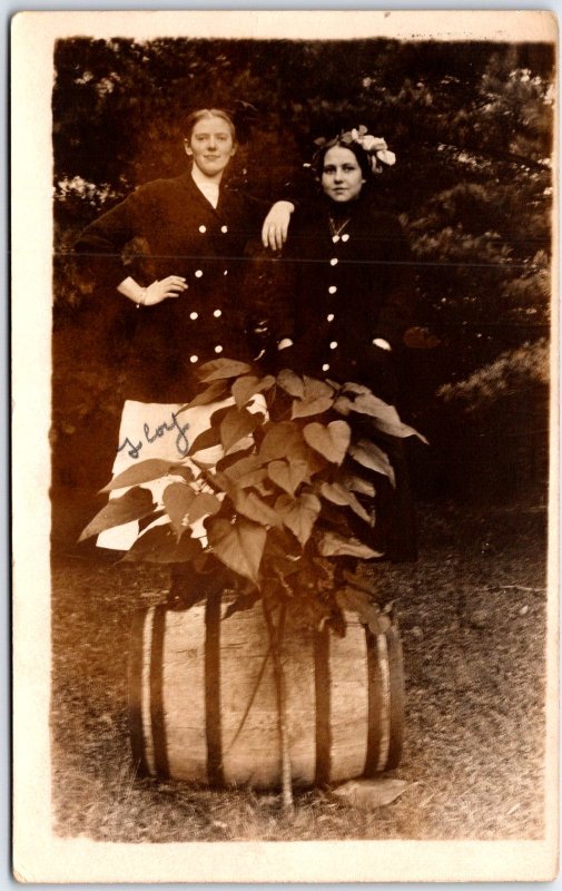 Two Women in Button Jacket Behind Tree with Barrel Portrait  - Vintage Postcard