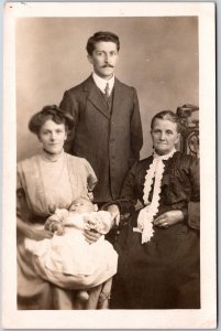 Family Picture Couple With The Baby and Grandmother Real Photo RPPC Postcard