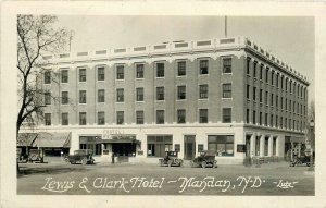 Postcard 1927 North Dakota Mandan Lewis Clark Hotel autos occupational ND24-3096