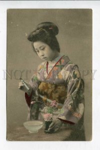 426737 JAPAN Geisha girl in native dress spraying flowers Vintage tinted RPPC