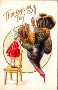 Thanksgiving Postcard Child with Knife Cutting Into Turkey Hanging by a Foot 