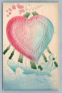 VALENTINE ANTIQUE EMBOSSED POSTCARD CUPID IN THE BOAT w/ HEART SAIL