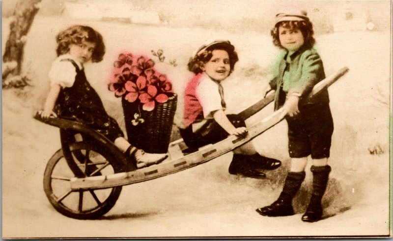  Postcard Wheelbarrow Children KIDS FLOWERS PHOTO 1910 UNPOSTED