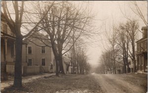 RPPC Street Scene in Winter Houses Woman Head Scarf Dirt Roads Postcard Z24