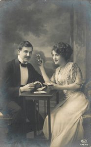 Romantic couple playing cards 1912 postcard