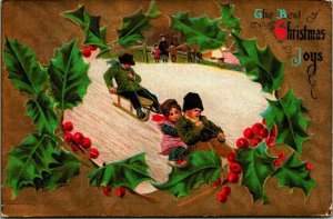 Holly Border Children Sledding Scene Best Christmas Joys Embossed 1909 Postcard
