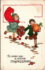 Thanksgiving Postcard Boy and Girl Running with Pumpkin and Basket of Apples