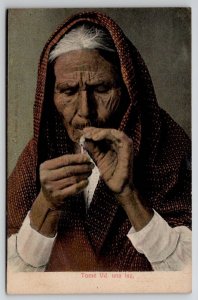 Old Woman Lights Cigarette Smoking Postcard G29