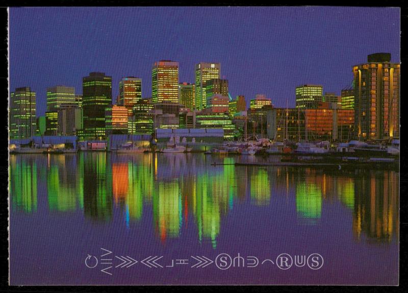 Vancouver, B.C. - The Vancouver skyline at night is reflected in the calm waters