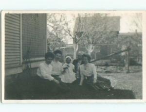 Pre-1917 rppc LITTLE GIRL IS THE CENTER OF ATTENTION OF THE ADULTS o2355