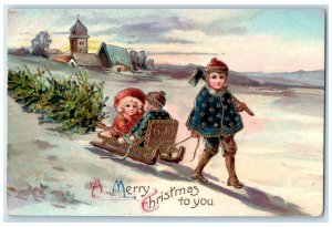 1912 Christmas Children Sledding With Pine Tree Hatchet Gel Gold Gilt Postcard