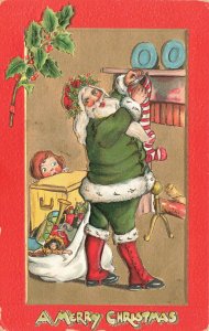 Merry Christmas Green Suited Santa Claus Hanging Stockings Embossed Postcard