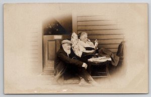 RPPC Old Man And Woman Sitting On Porch She Reads Book Real Photo Postcard P26