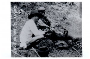 Igorottes living in the Mountains of the Philippines cooking dog RPPC Postcard