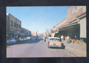 NUEVO LAREDO MEXICO DOWNTOWN STREET SCENE OLD CARS STORES VINTAGE POSTCARD