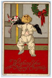 c1910's Christmas Boy Carrying Stockings Full Of Toys Embossed Antique Postcard