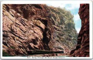 VINTAGE POSTCARD RAILWAY TRAIN PASSING THROUGH THE ROYAL GORGE IN COLORADO