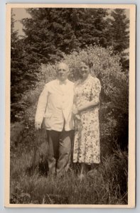 RPPC Lovely Older Man and Women Tall Grasses Flower Bush Real Photo Postcard H23