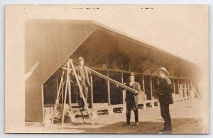 RPPC Lumber Yard Barn Men Showing Quality of Wood Real Photo Postcard T22