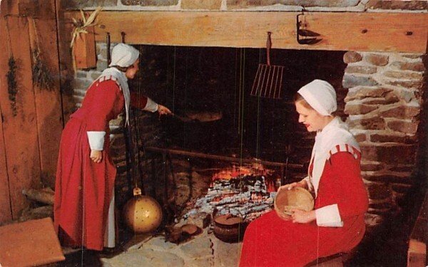 Pilgrim women in Plymouth, MA prepare evening meat at First House.