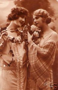 old postcard 2 ROMANTIC YOUNG WOMEN hold FLOWERS