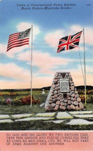 North Dakota ND  CAIRN~INTERNATIONAL PEACE BORDER~FLAGS Manitoba Canada Postcard