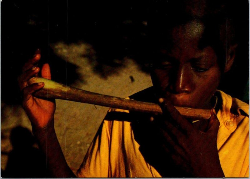 VINTAGE CONTINENTAL SIZE POSTCARD YOUNG KENYAN BOY PLAYING FLUTE + ETHIOPIA REAR