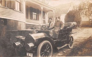 People in Car outside of House Automobile Real Photo Vintage Postcard AA67701