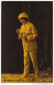 RP; Woman wearing pajamas holding lit candle, 20-30s